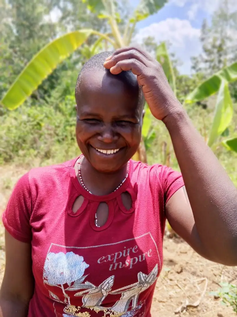Liz Akinyi, farmer in Siaya County, laughing