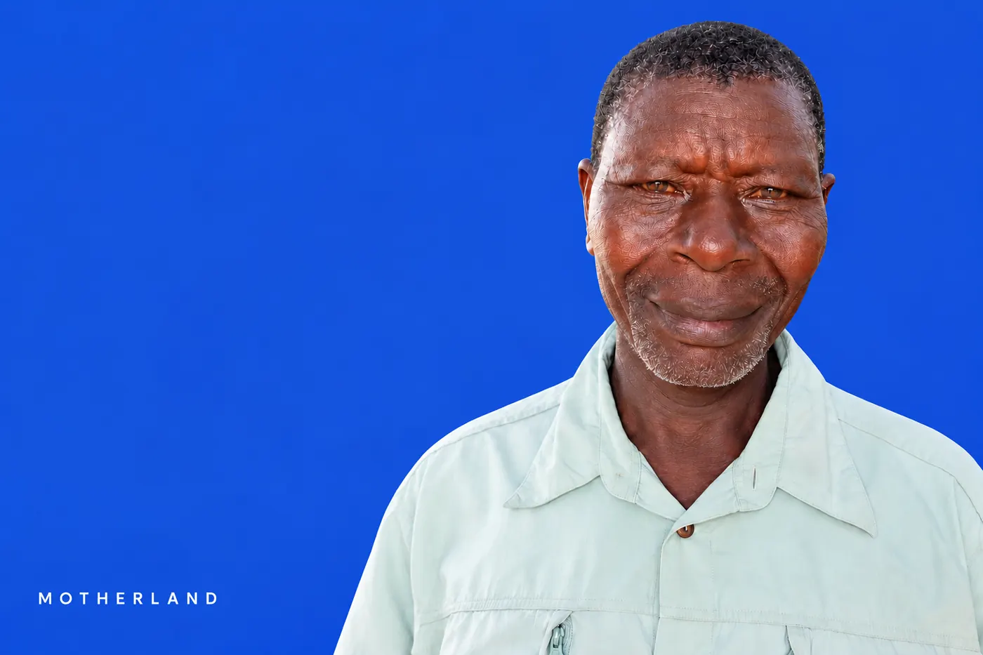 Farmer from Siaya County in a light shirt, smiling